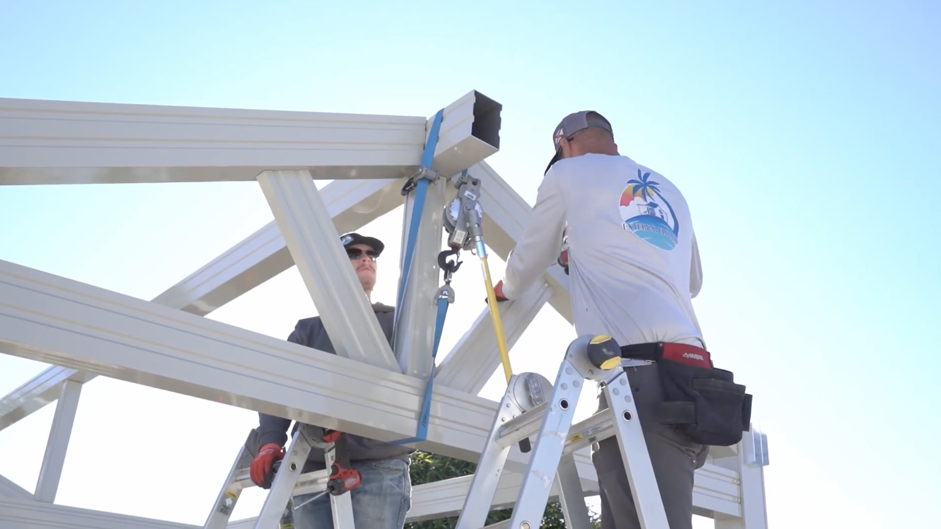Deck builder crew assembling a kit in a backyard